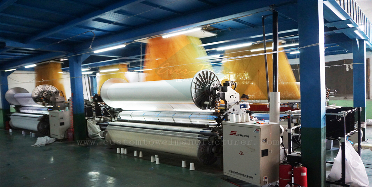 A clean and modern textile factory showing looms weaving bamboo fabric.